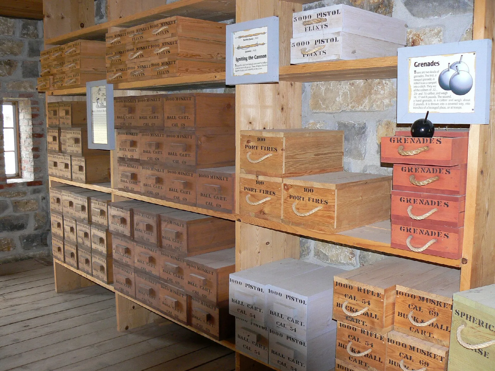 Shelves of wooden ammunition boxes inside a stone powder magazine