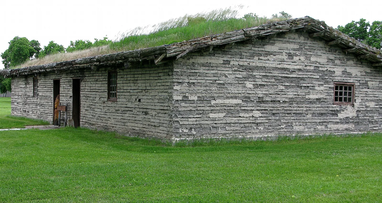 Low sod-roofed building with stone-like walls and a grass roof