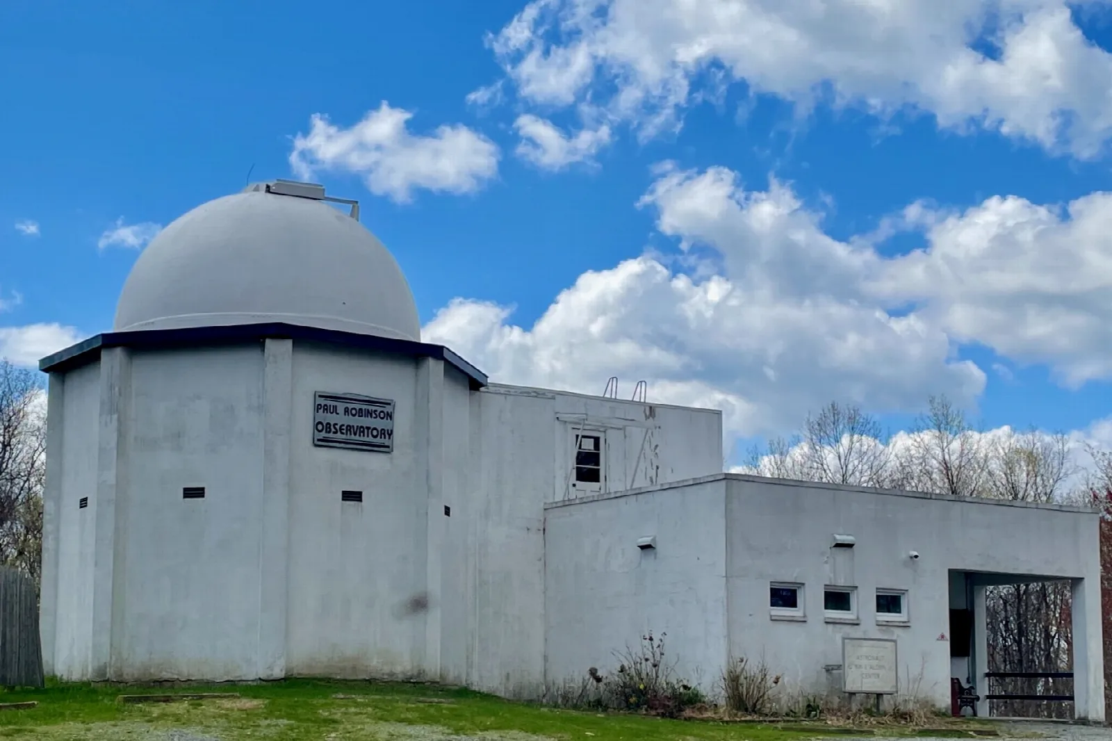White observatory building with a dome under a blue sky