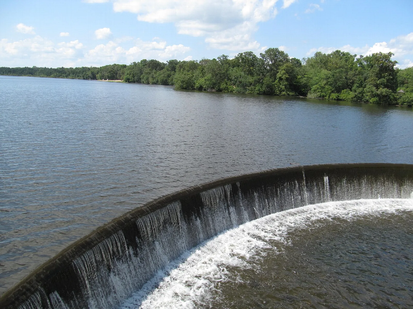 Curved spillway with water flowing over a dam