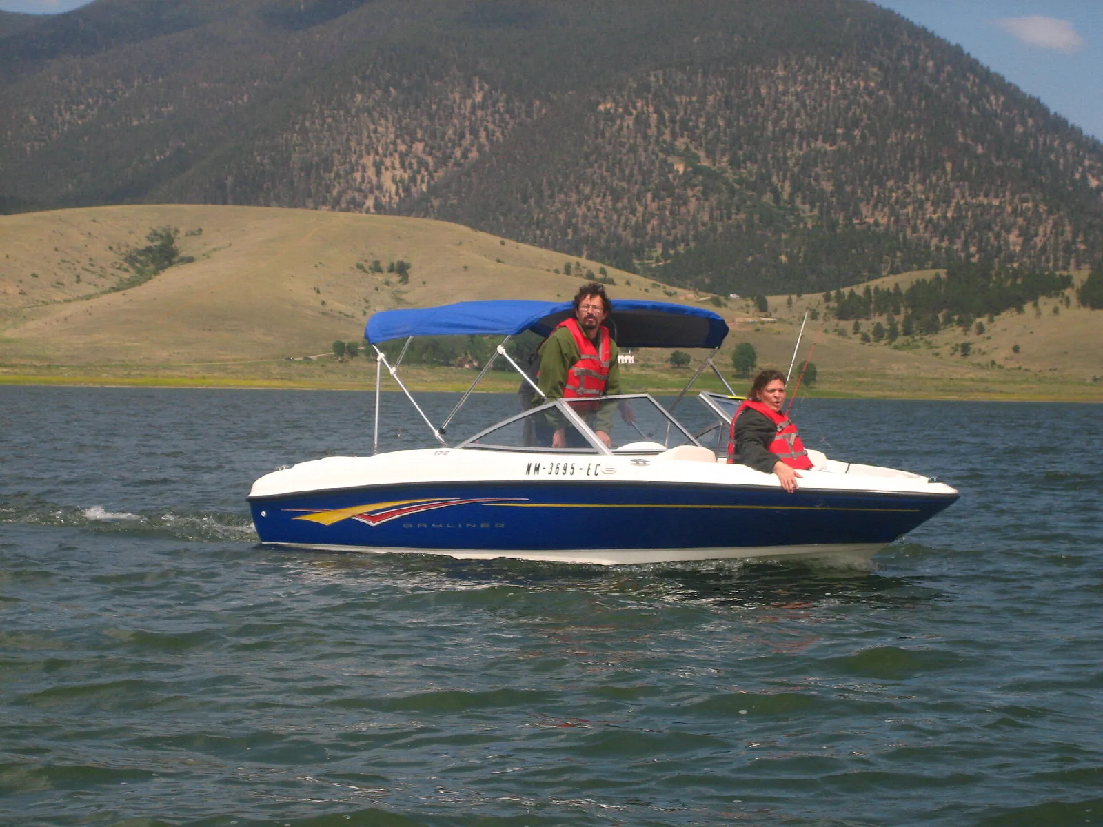 Motorboat with two people on a mountain lake