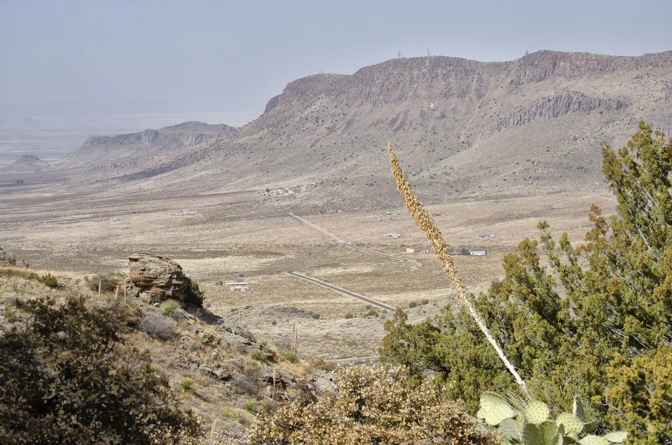 Dry mountain ridge and desert plain seen from a canyon