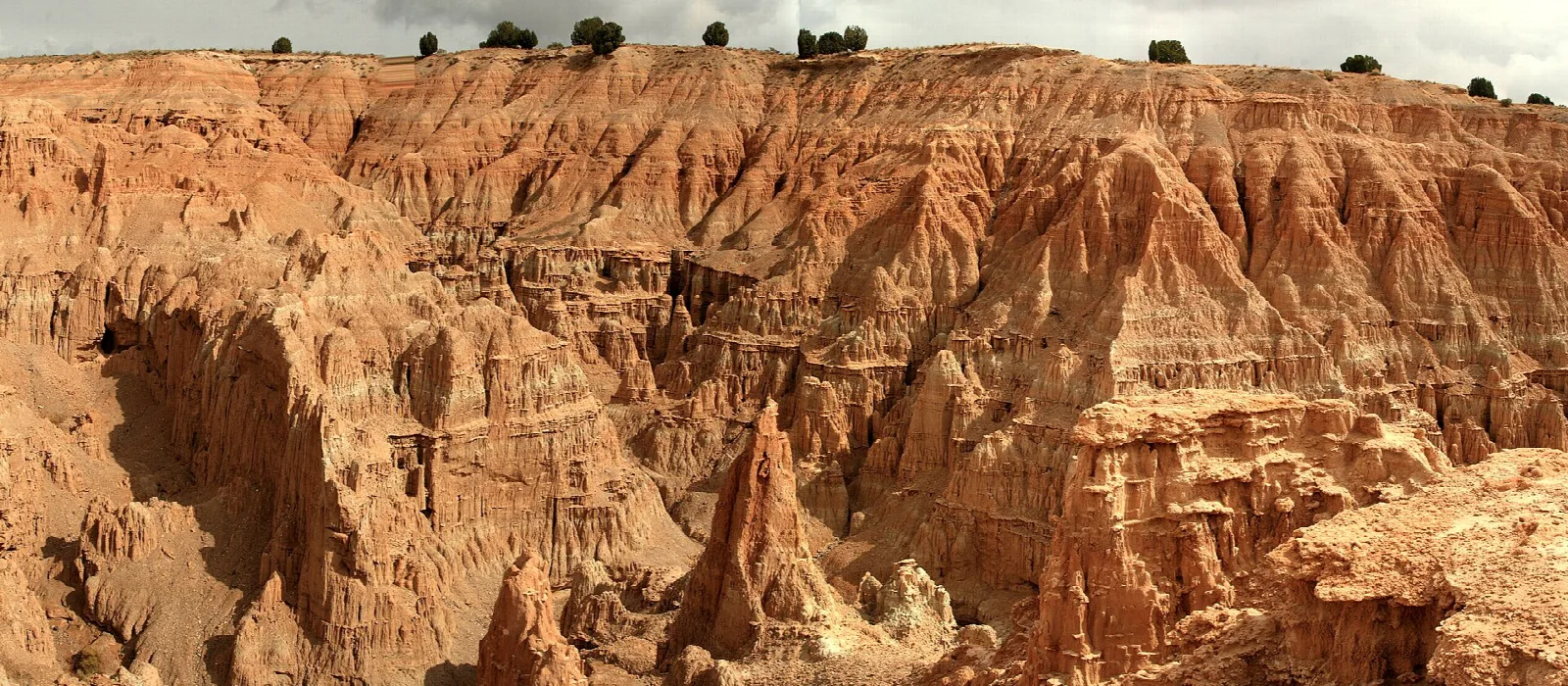 Wide view of eroded canyon walls and clay formations