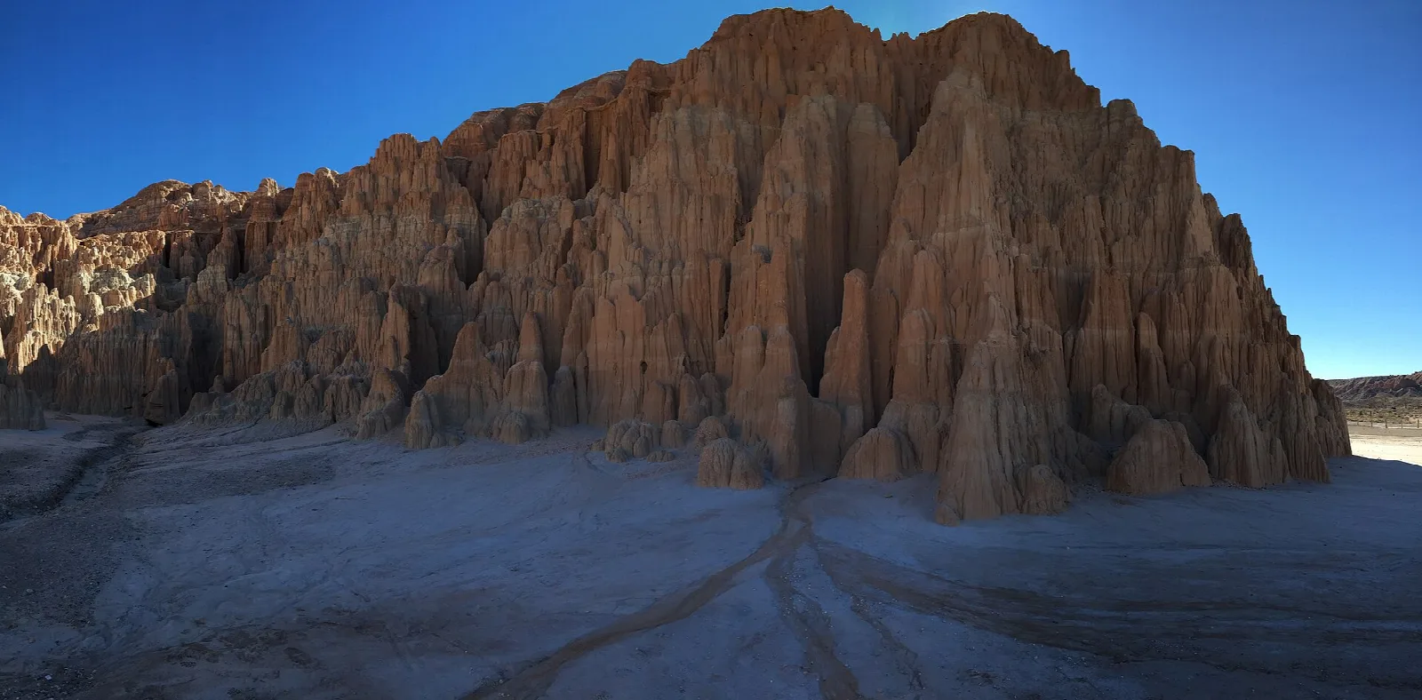 Large eroded clay bluff under a blue sky
