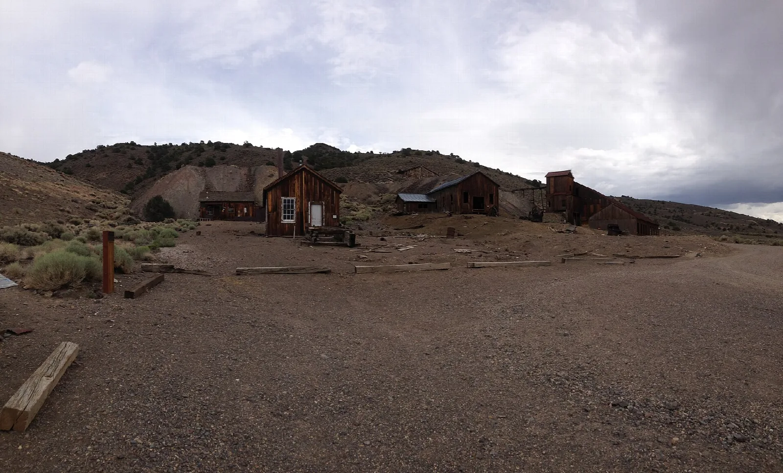 Weathered wooden buildings of the ghost town under a stormy sky