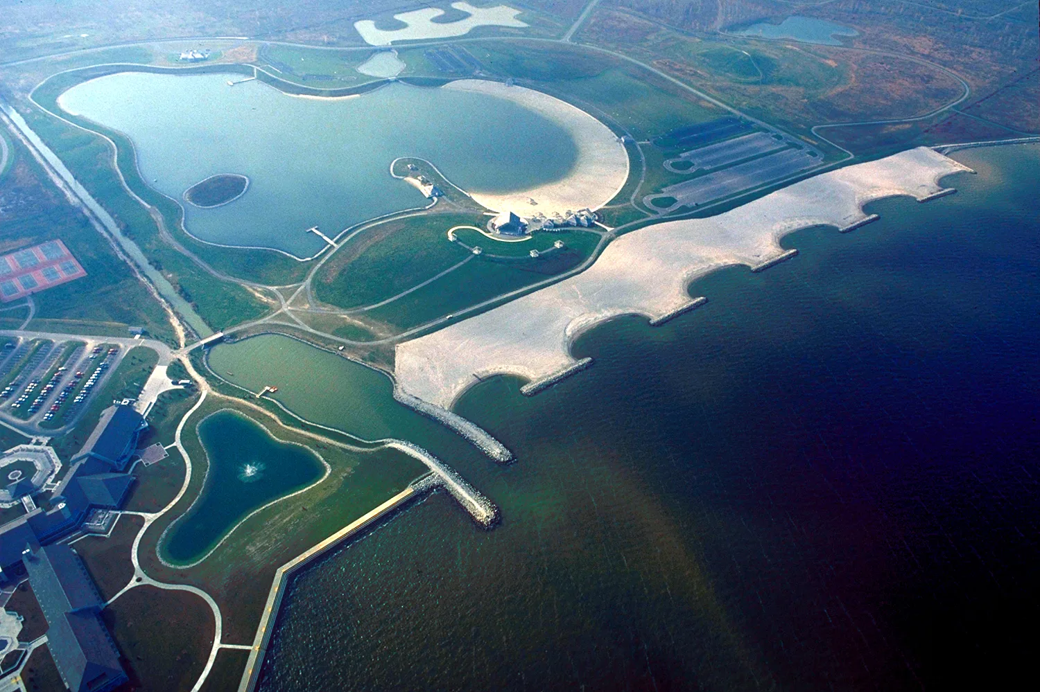 Aerial view of a lakeside park with an inland lake and a sandy beach on Lake Erie