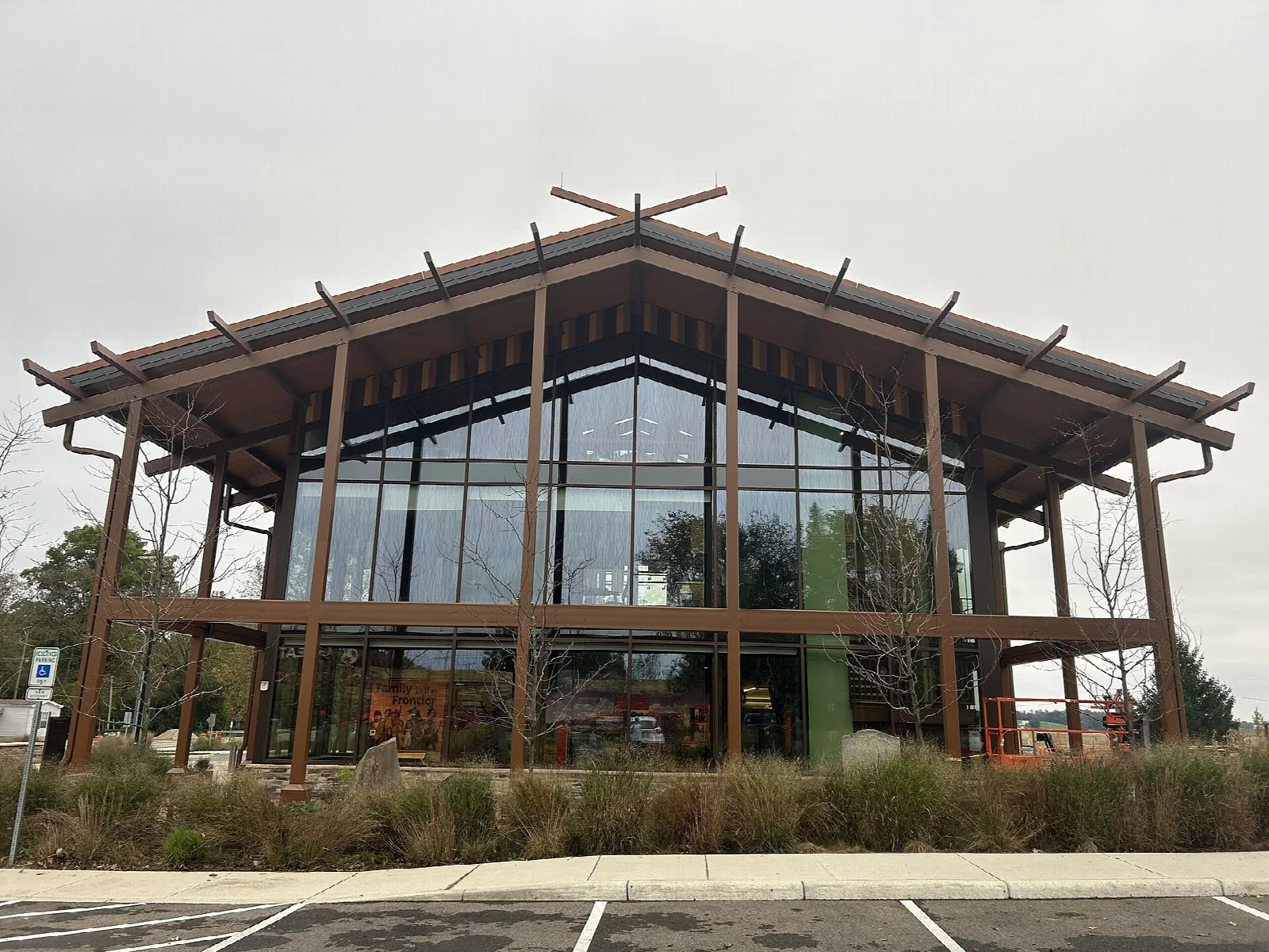 Modern timber-and-glass interpretive center with a wide peaked roof