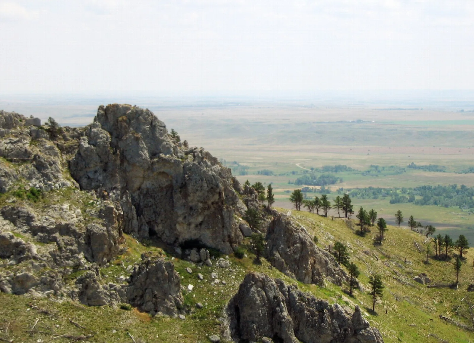 Rocky outcrop on a hillside above wide plains