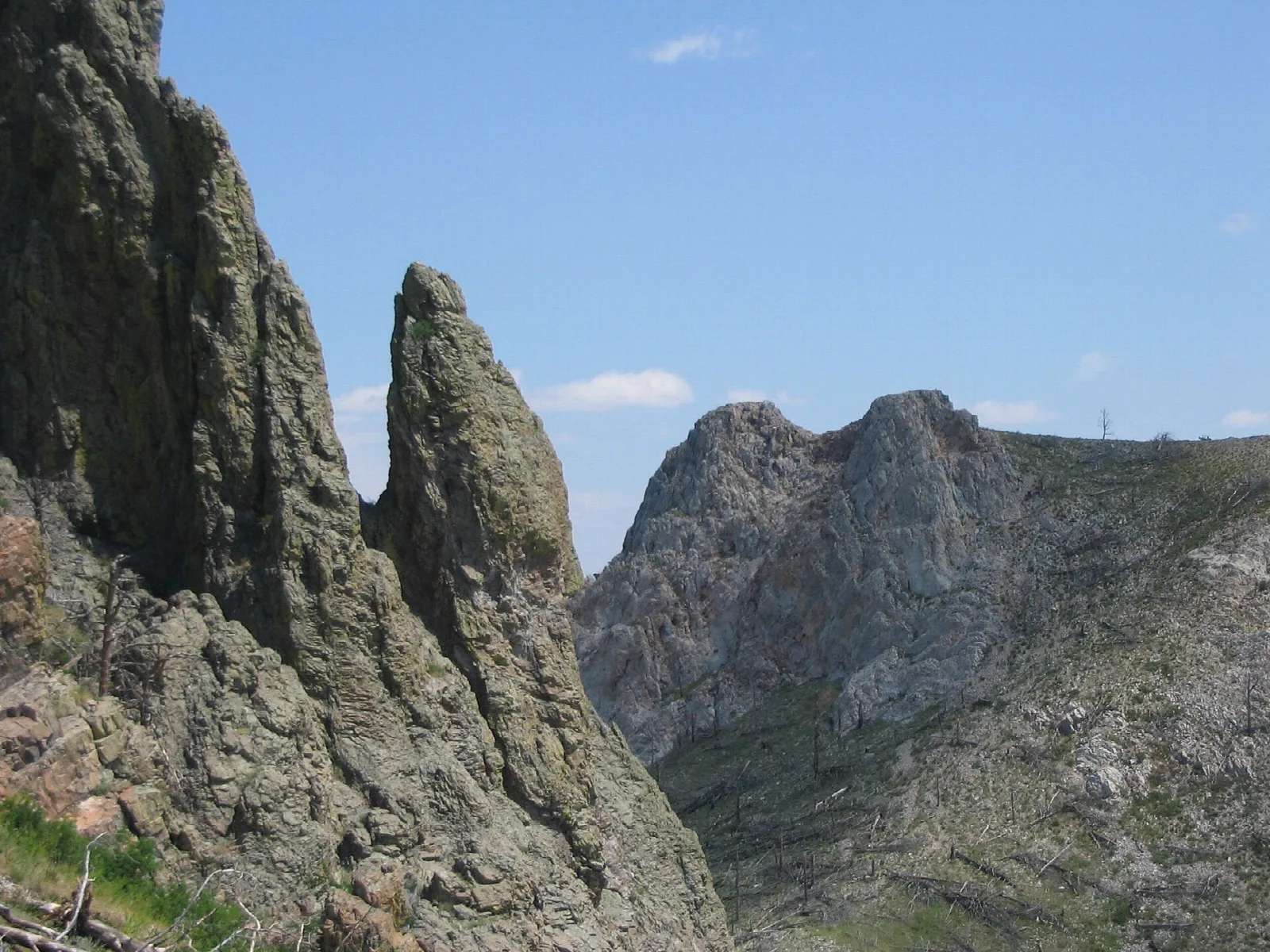 Jagged rock spires on the butte against a blue sky