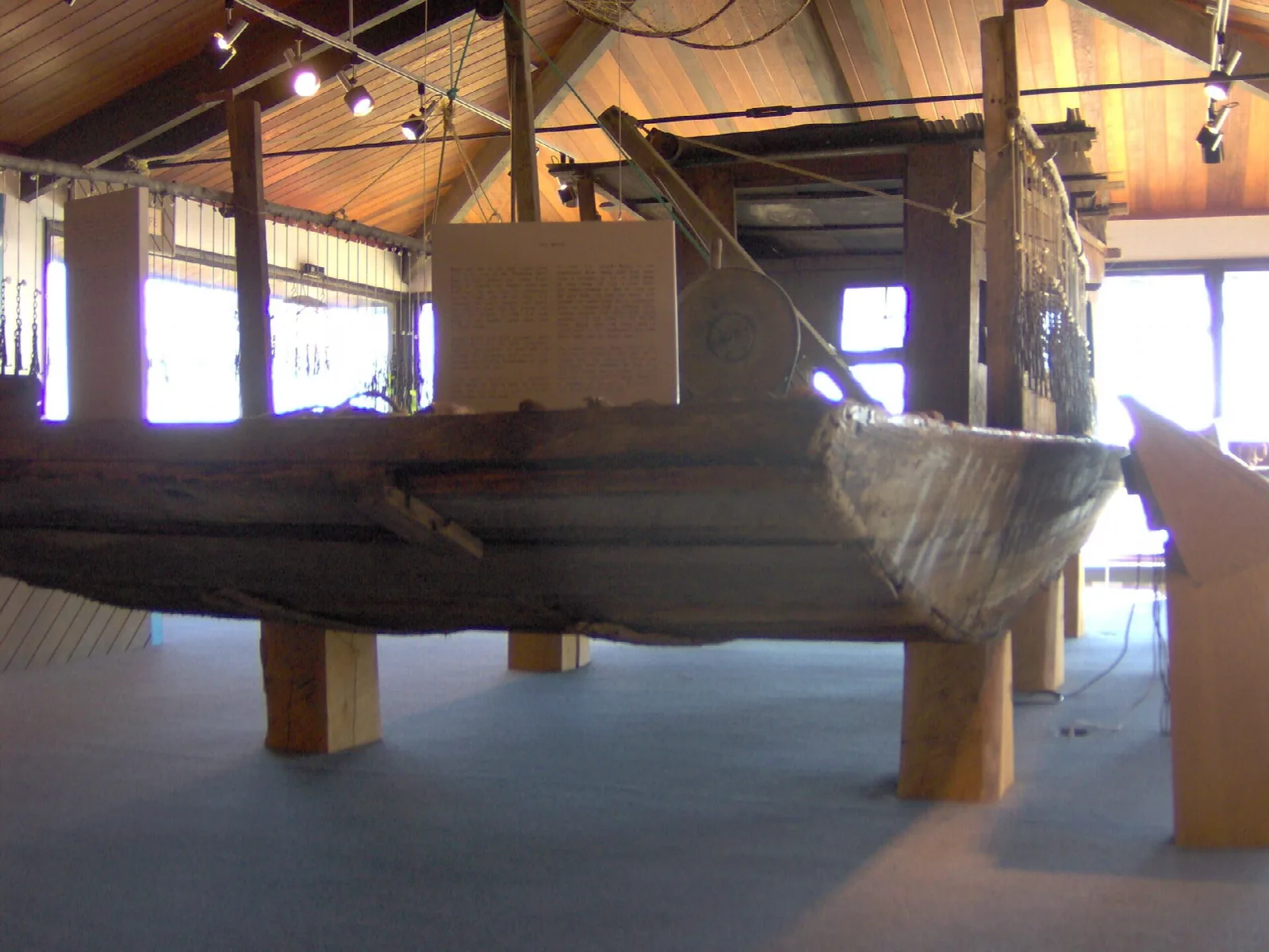 Wooden jon boat displayed inside a museum hall