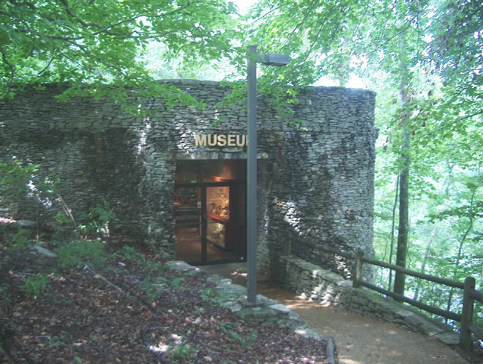 Stone museum entrance with a Museum sign in the forest