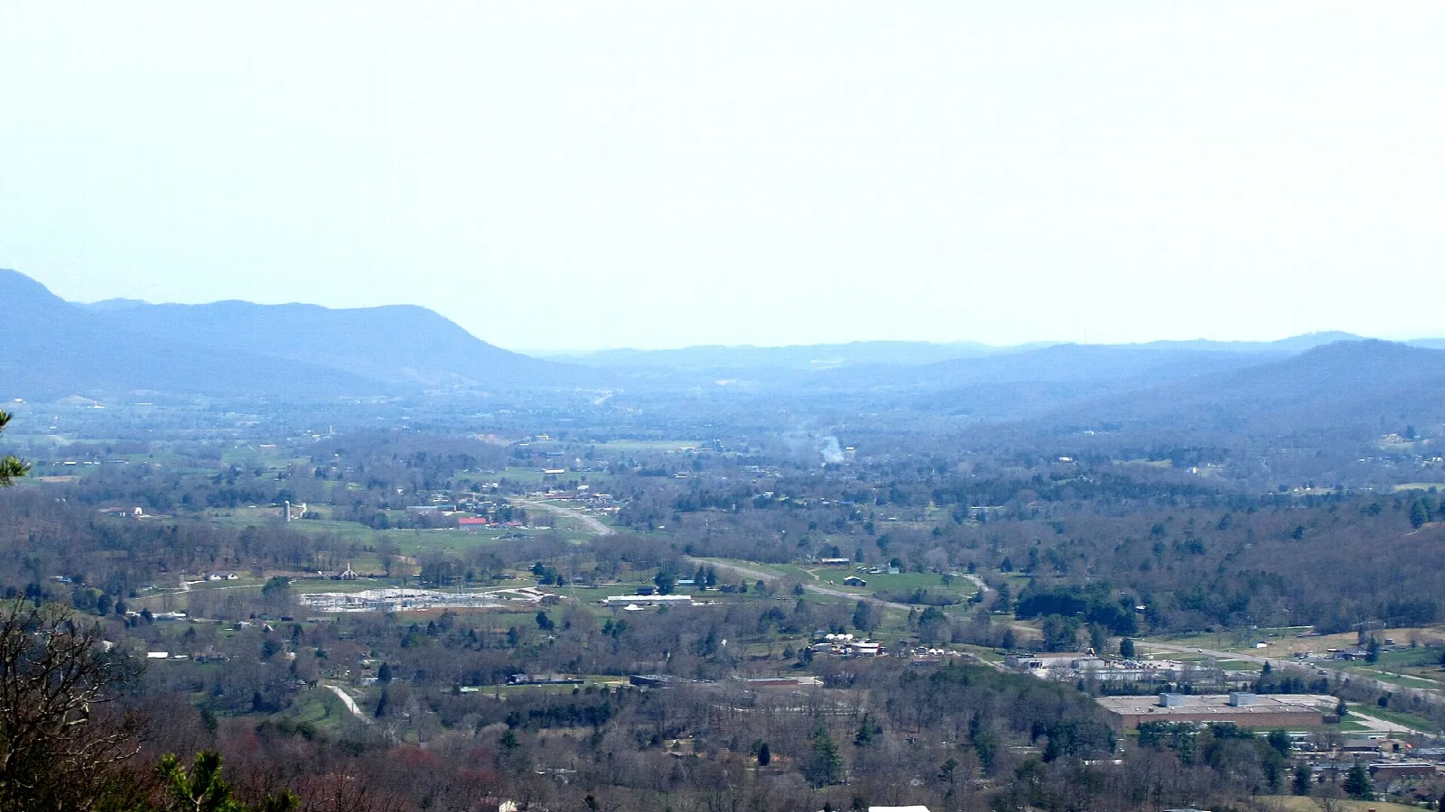 Wide valley with a town seen from a mountain crest