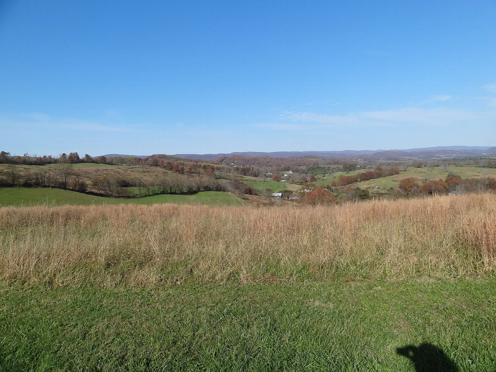 Open grassy field with rolling hills in the distance