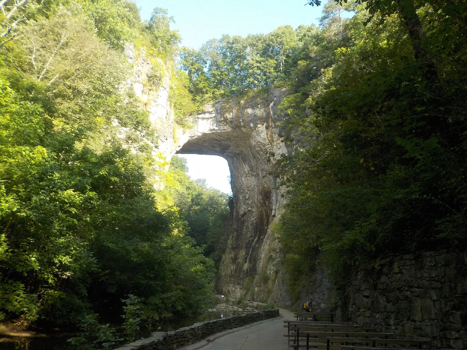 Arch seen down a tree-lined path in the gorge