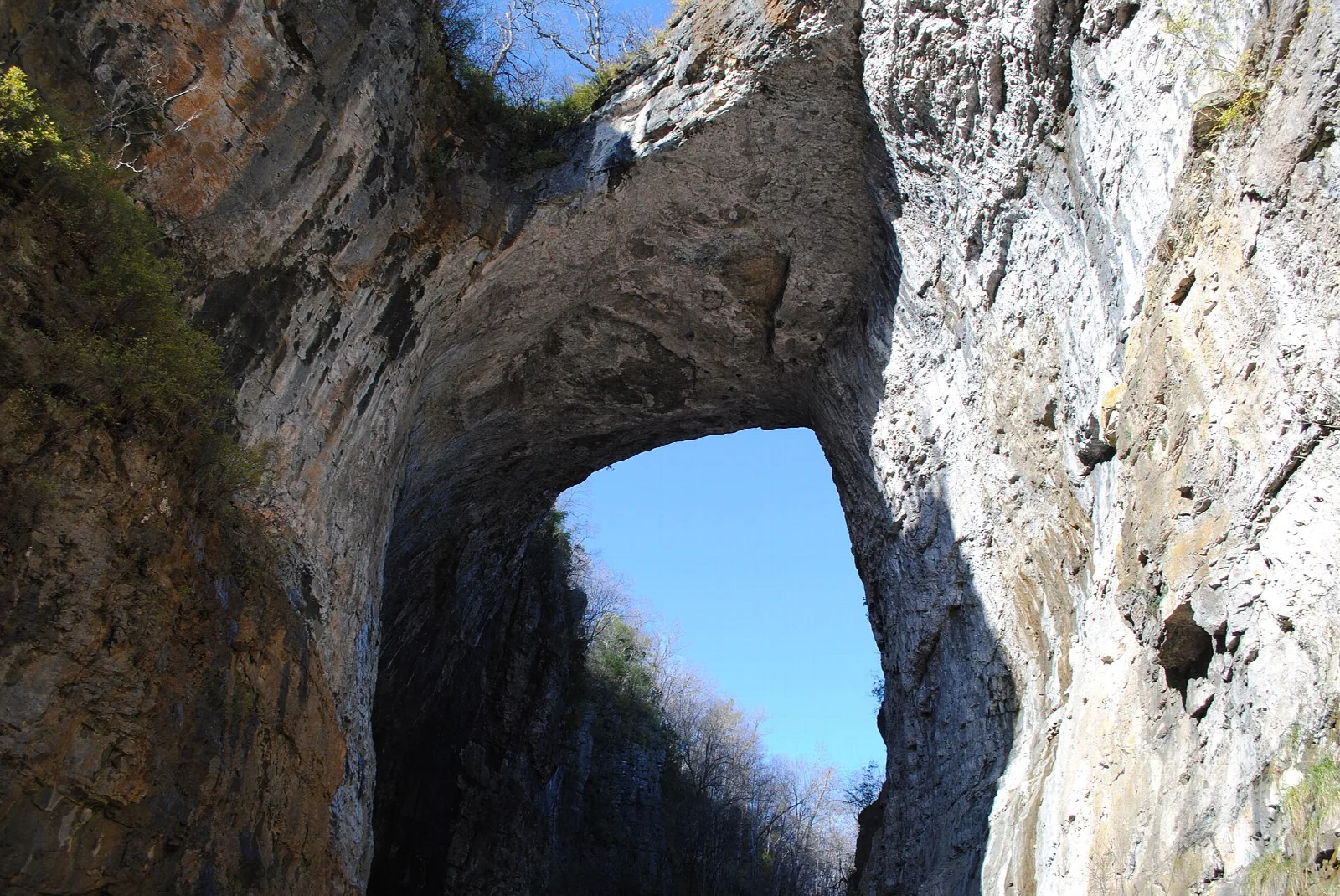 Rock walls and arch opening with blue sky beyond