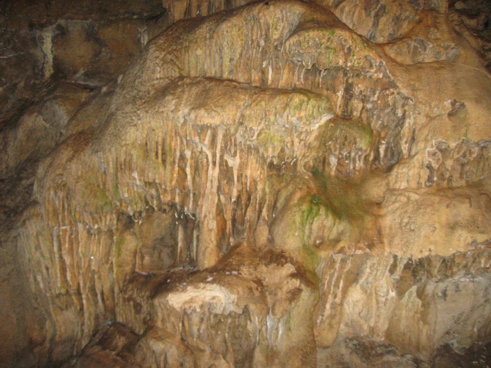 Rippled limestone cave wall in warm light