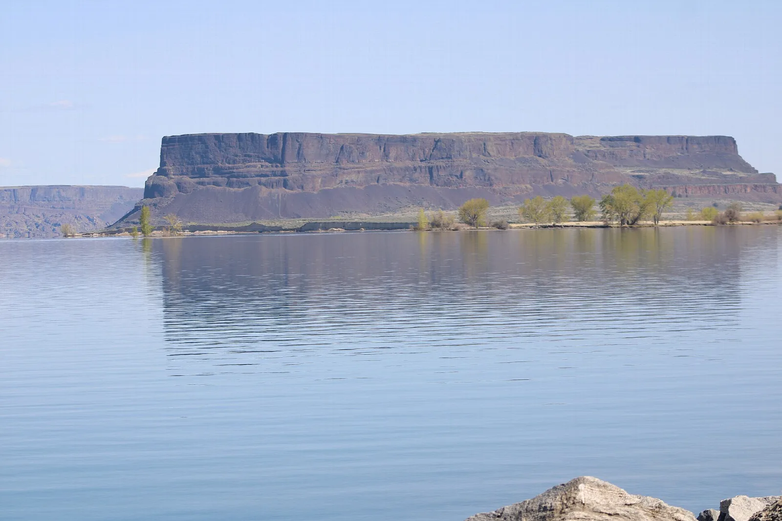 Flat-topped Steamboat Rock rising from calm Banks Lake