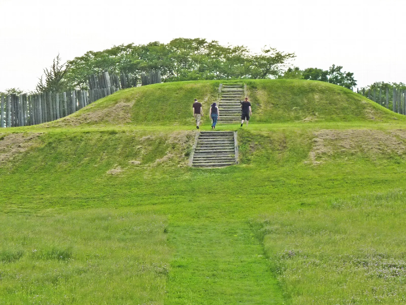 Wooden steps up the side of a grassy platform mound