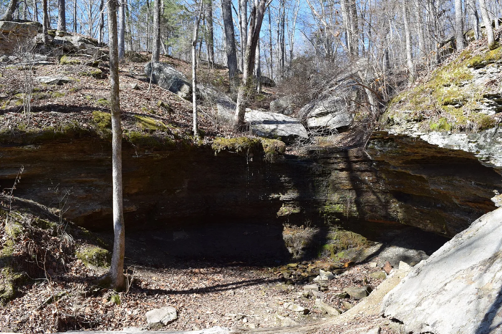 Rock overhang above a dry stream bed in the woods
