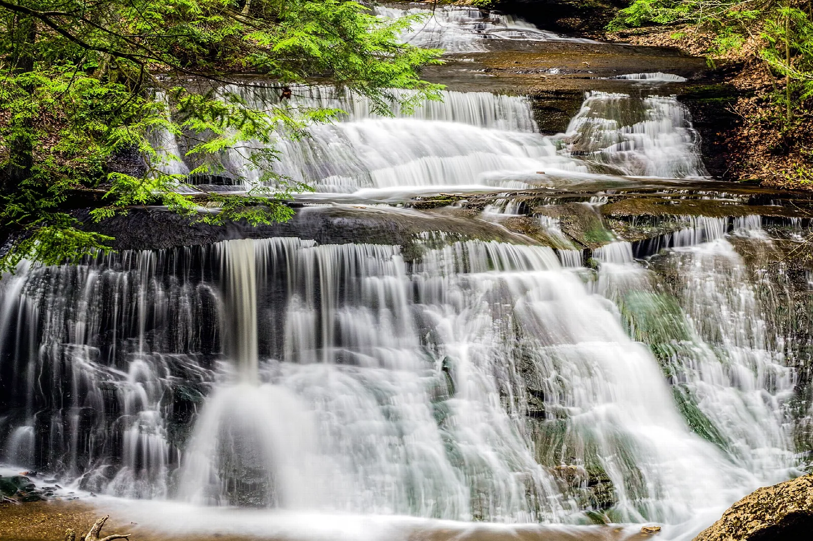 Broad cascade of waterfalls over stepped rock