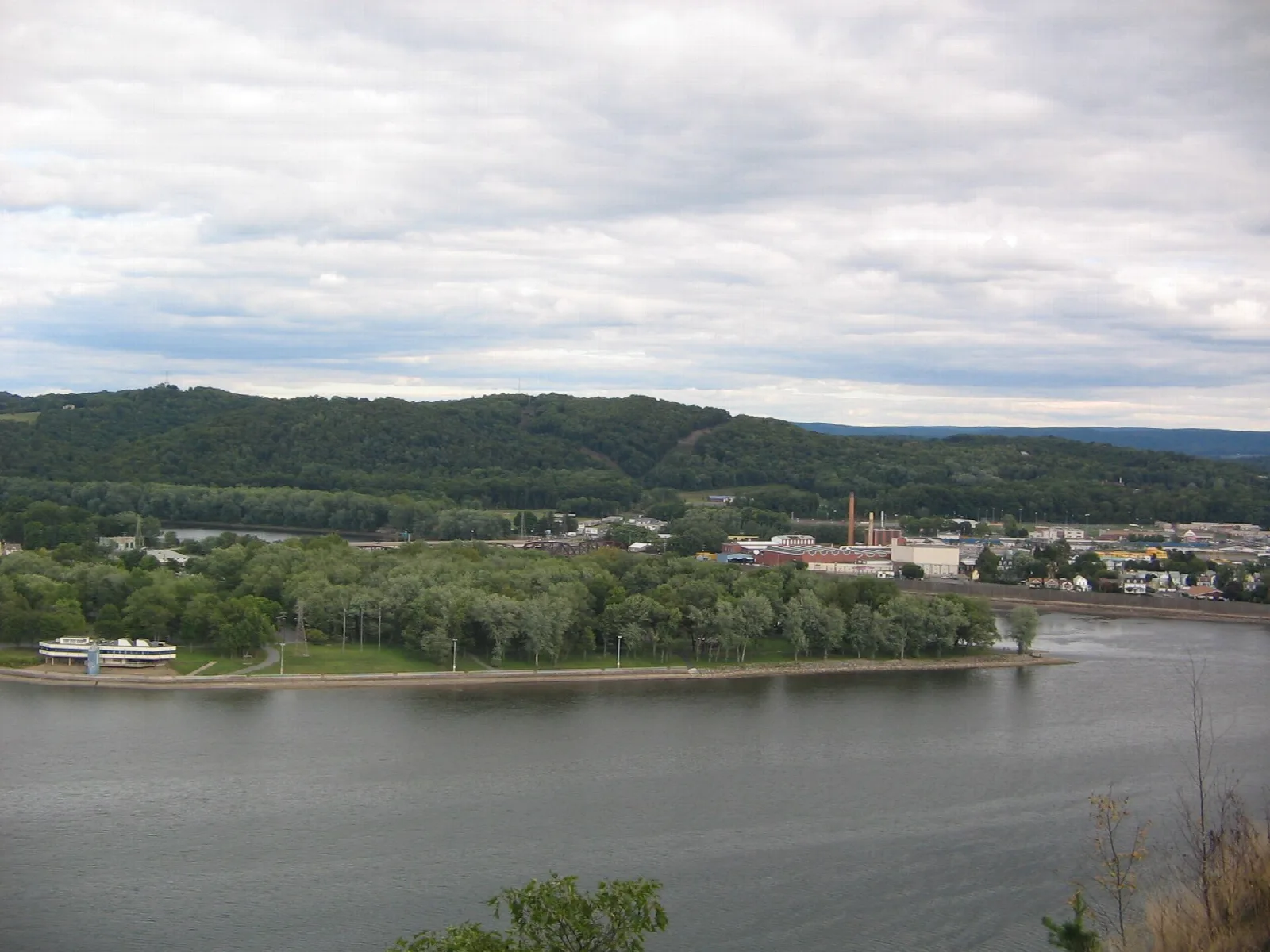 Wide river and a green island with a marina building
