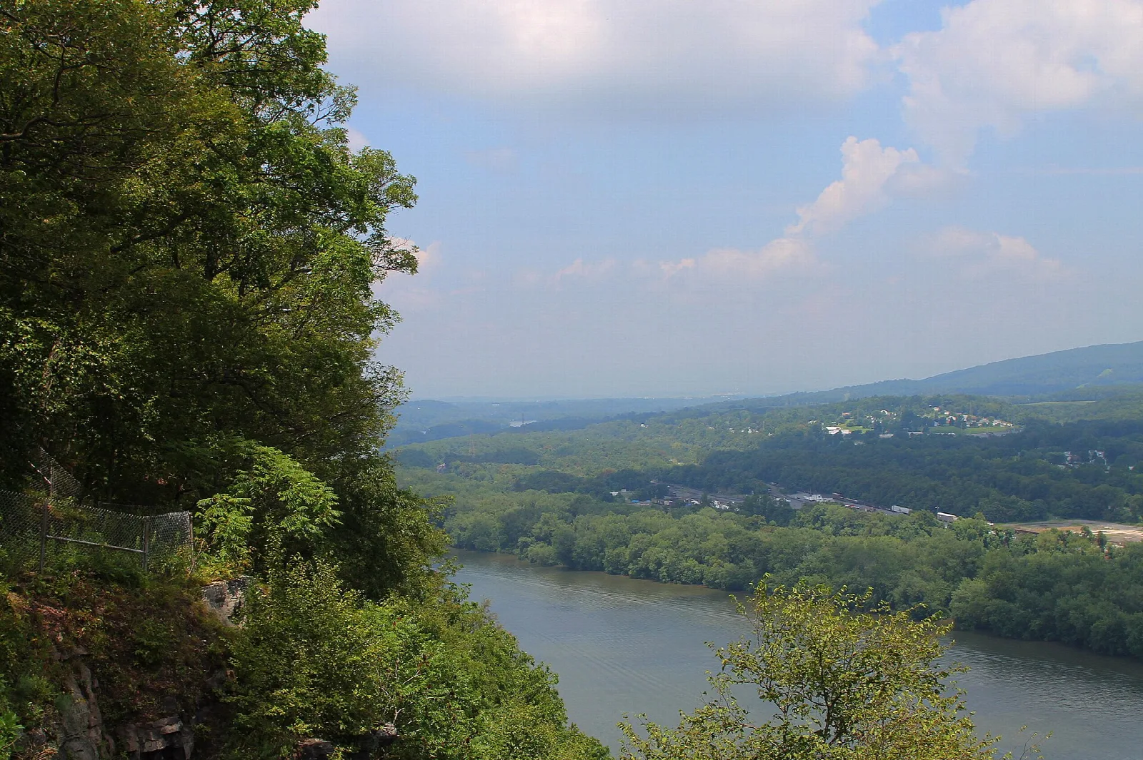 River valley seen through trees from a cliff overlook