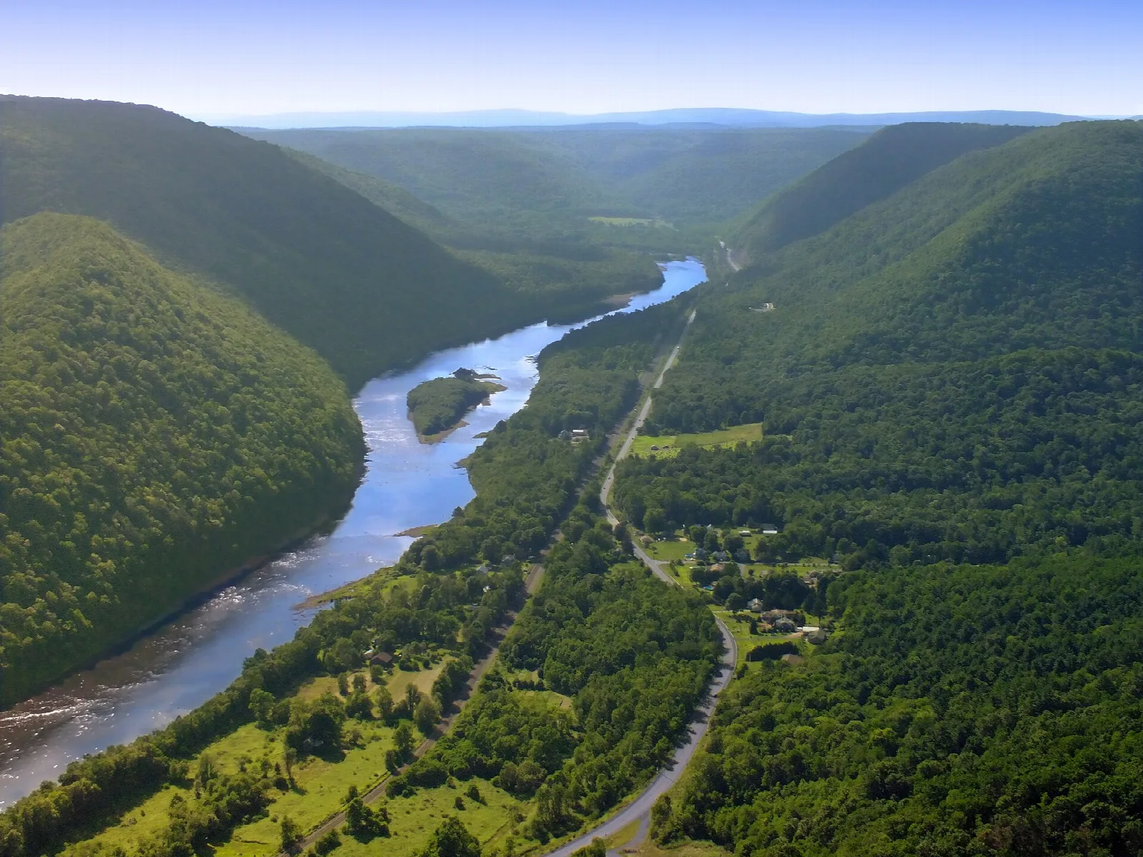 River curving through green mountains seen from above
