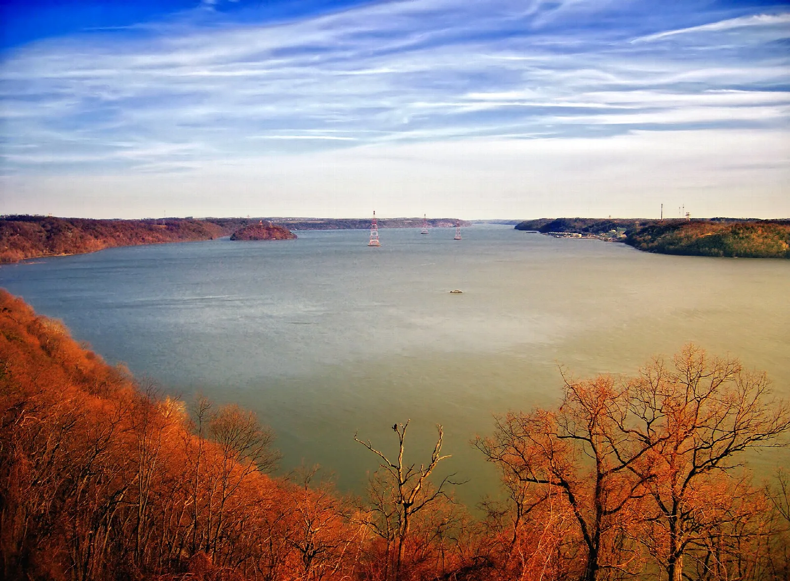 Wide river seen from a cliff edge with orange autumn trees
