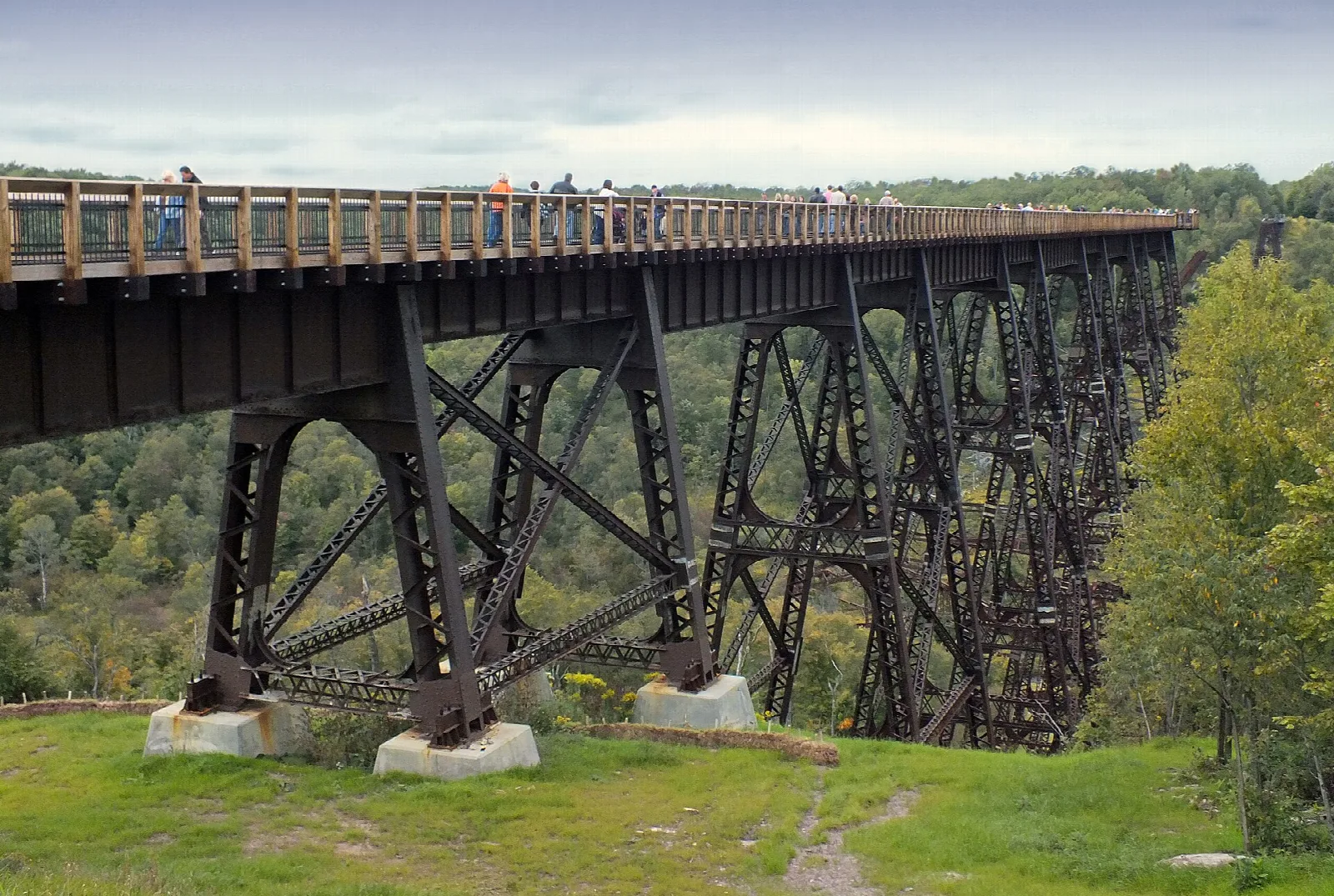 Steel trestle with a walkway above and visitors on top