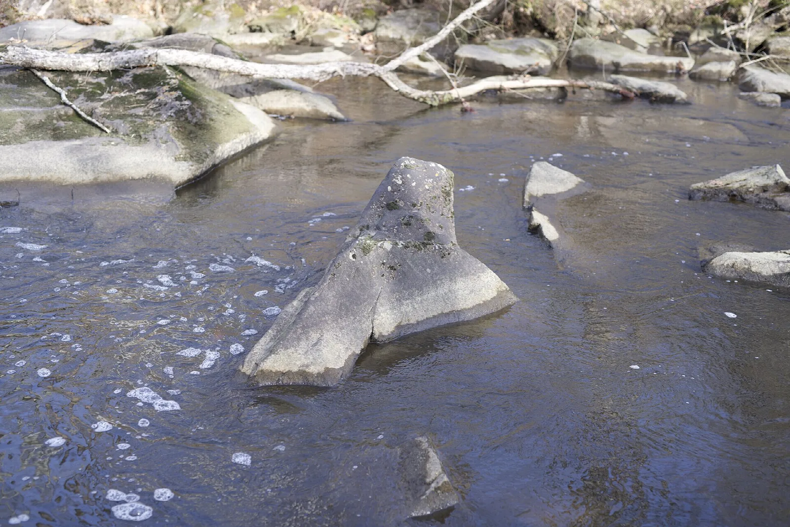 Large boulders in a shallow, bubbling stream