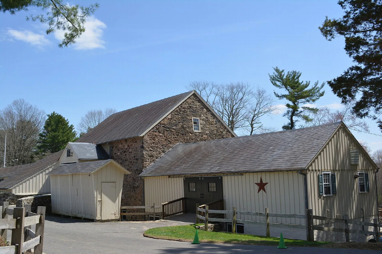 Stone and wood farm buildings under a blue sky