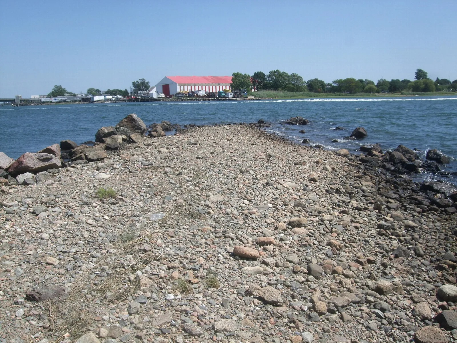 A rocky spit of stones reaching out into the water