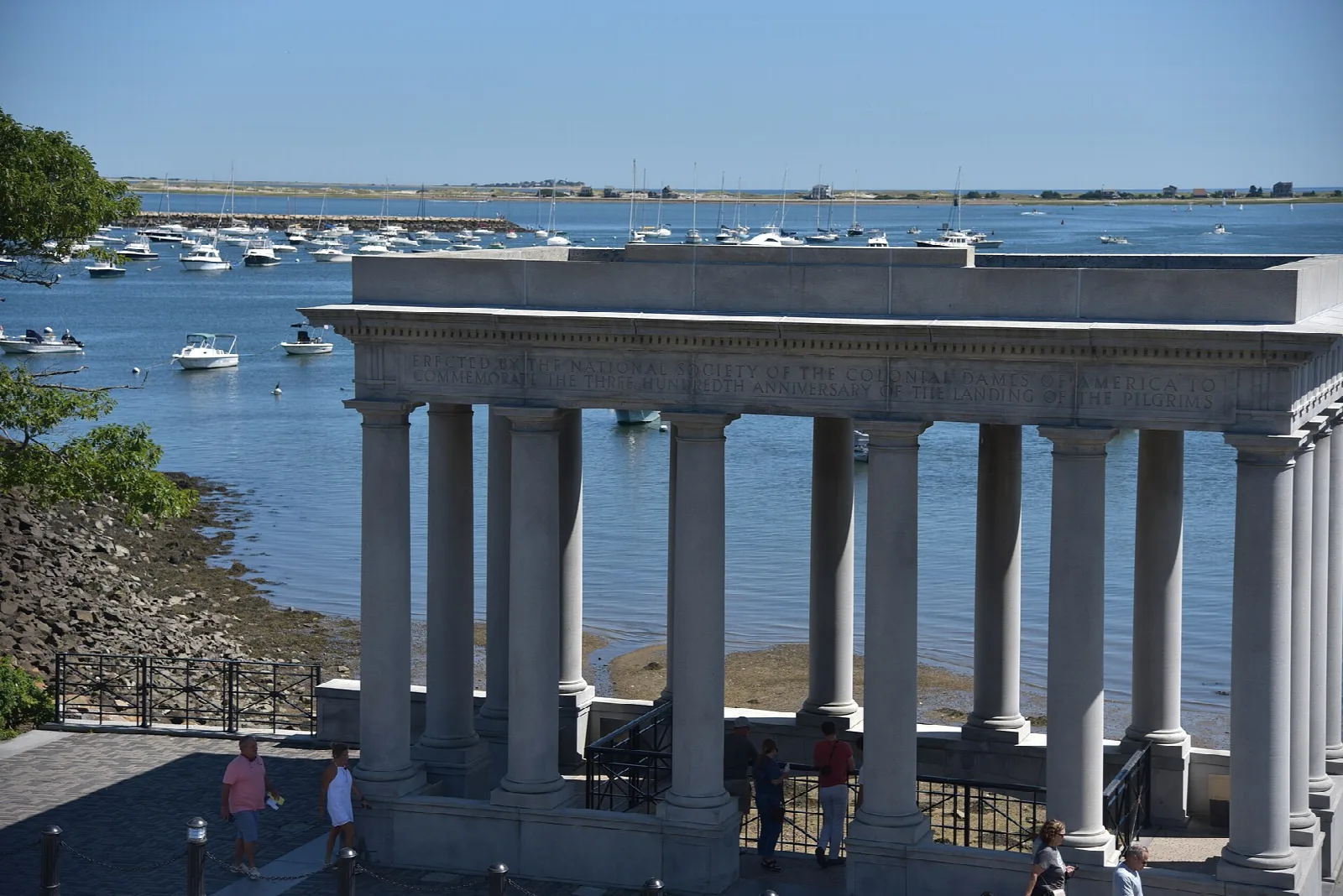 A white columned portico beside a harbor full of boats