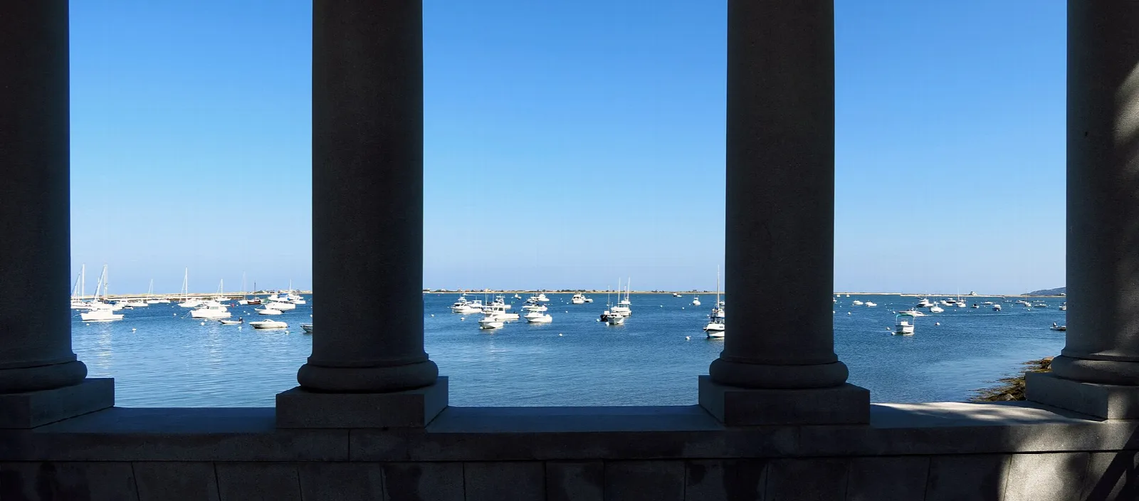 Harbor and boats seen between stone columns