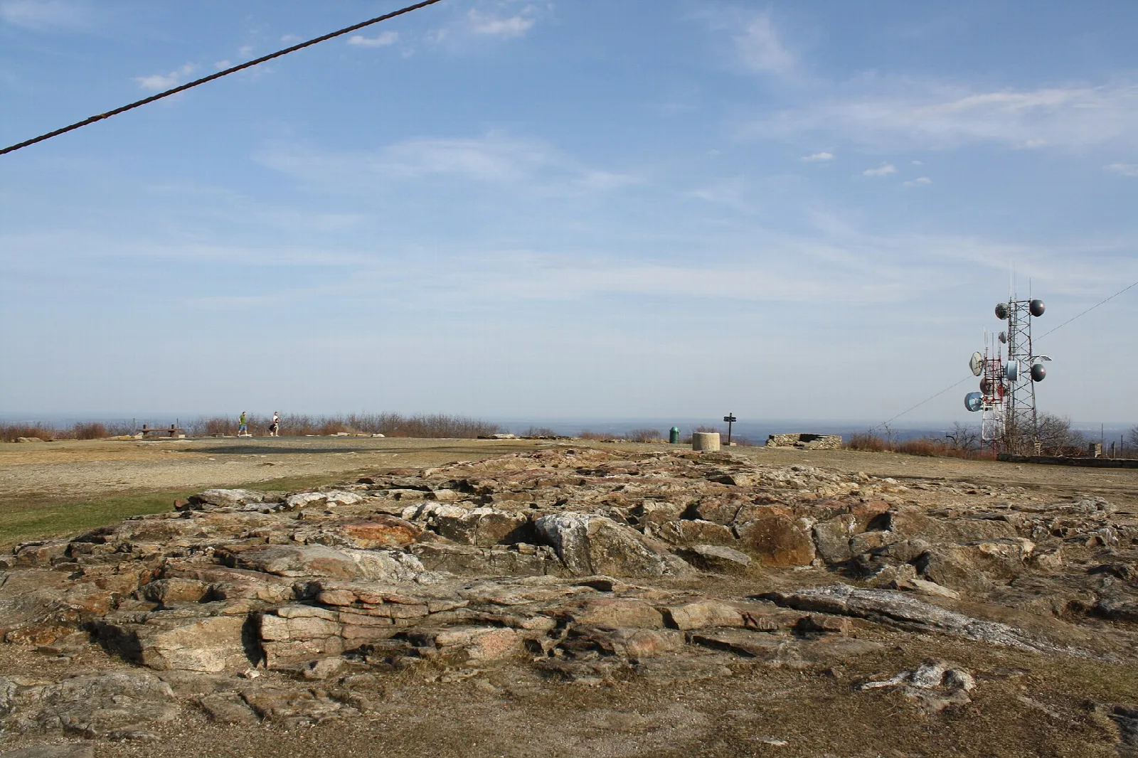 Open rocky summit with a radio tower in the distance