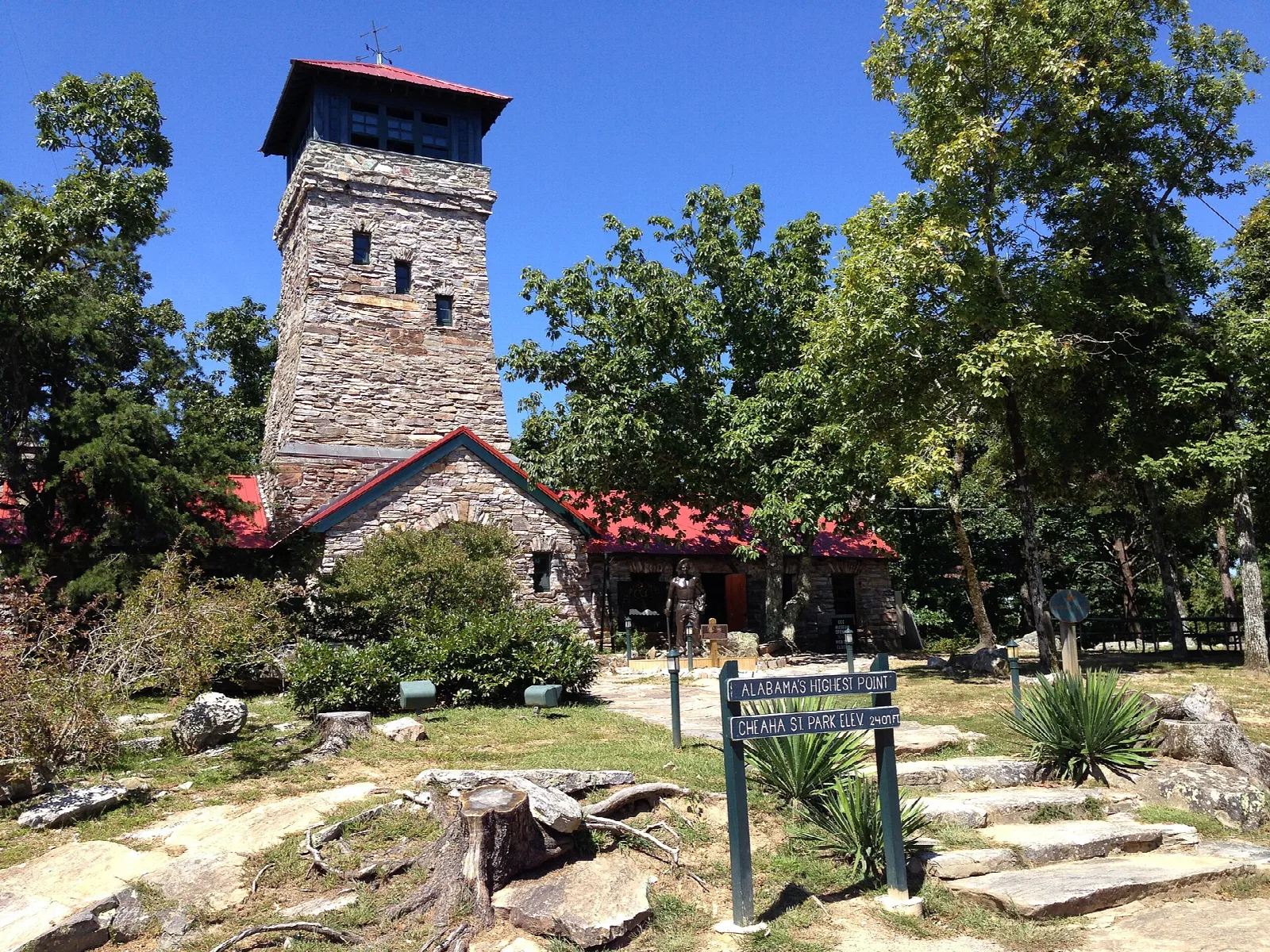 Stone observation tower with a red roof on a rocky hilltop