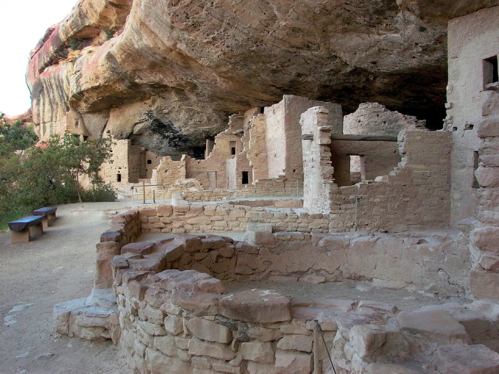 Well-preserved stone rooms and towers in a shaded alcove