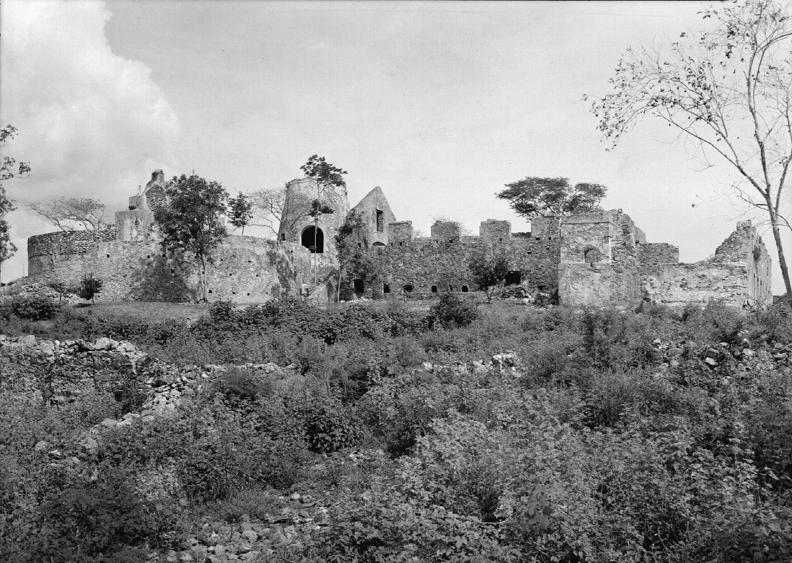 Black-and-white photograph of stone sugar mill ruins on a hillside