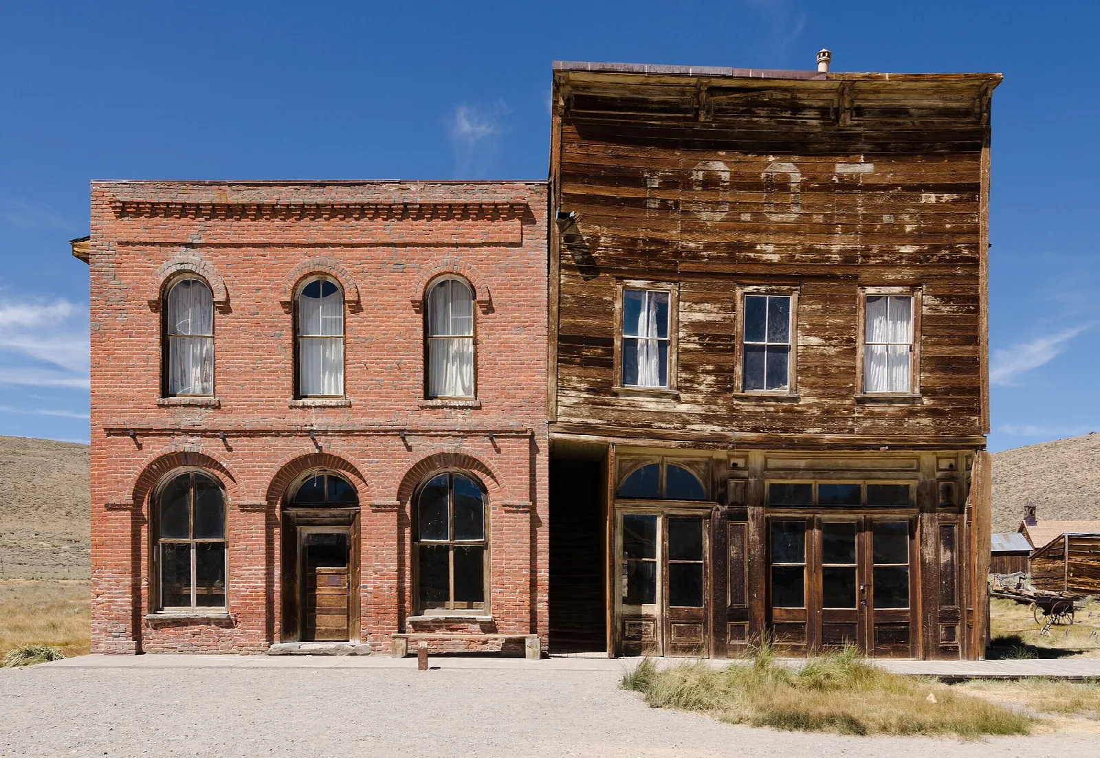 Brick and wooden two-story buildings on a dirt street