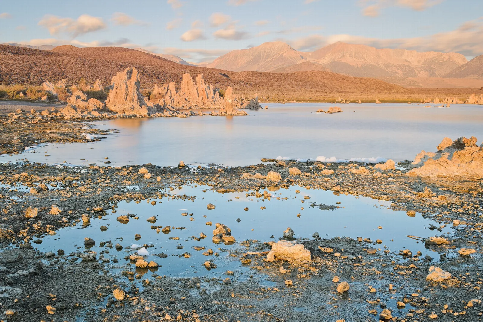 Tufa towers on the lake shore with mountains beyond