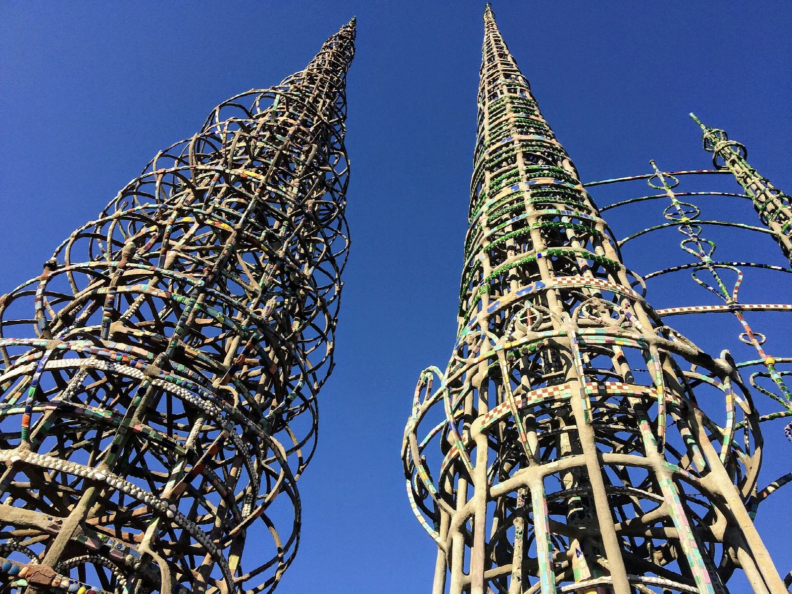Tall lattice towers of wire and tile against a blue sky