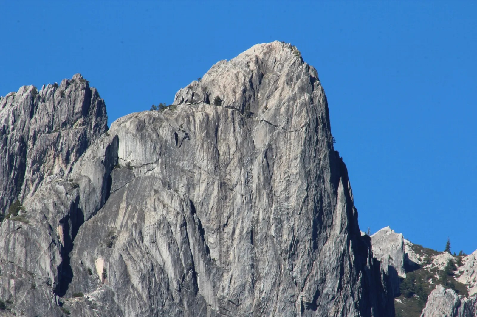 Sheer gray granite dome against a blue sky