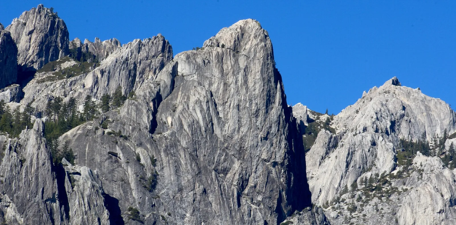 Tall gray granite spires against a blue sky