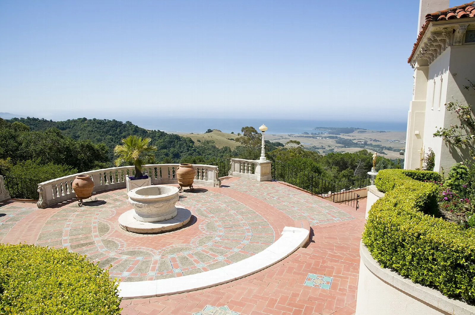Brick terrace with a fountain and ocean view