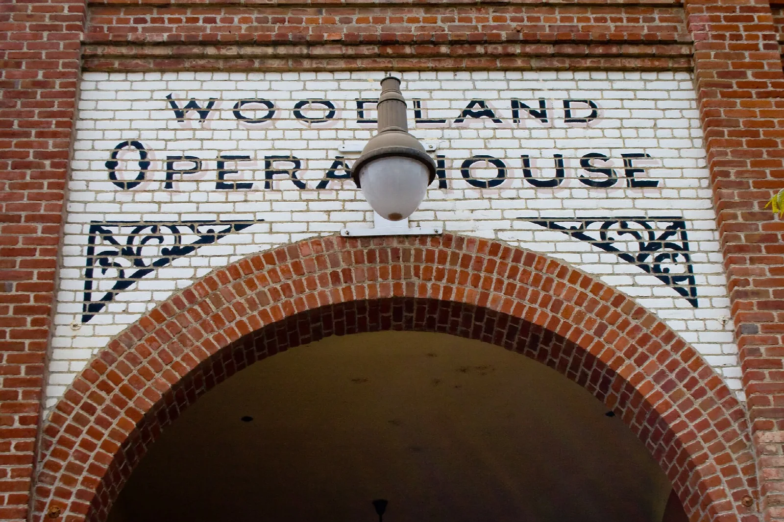 Brick arched entrance with Woodland Opera House lettered above