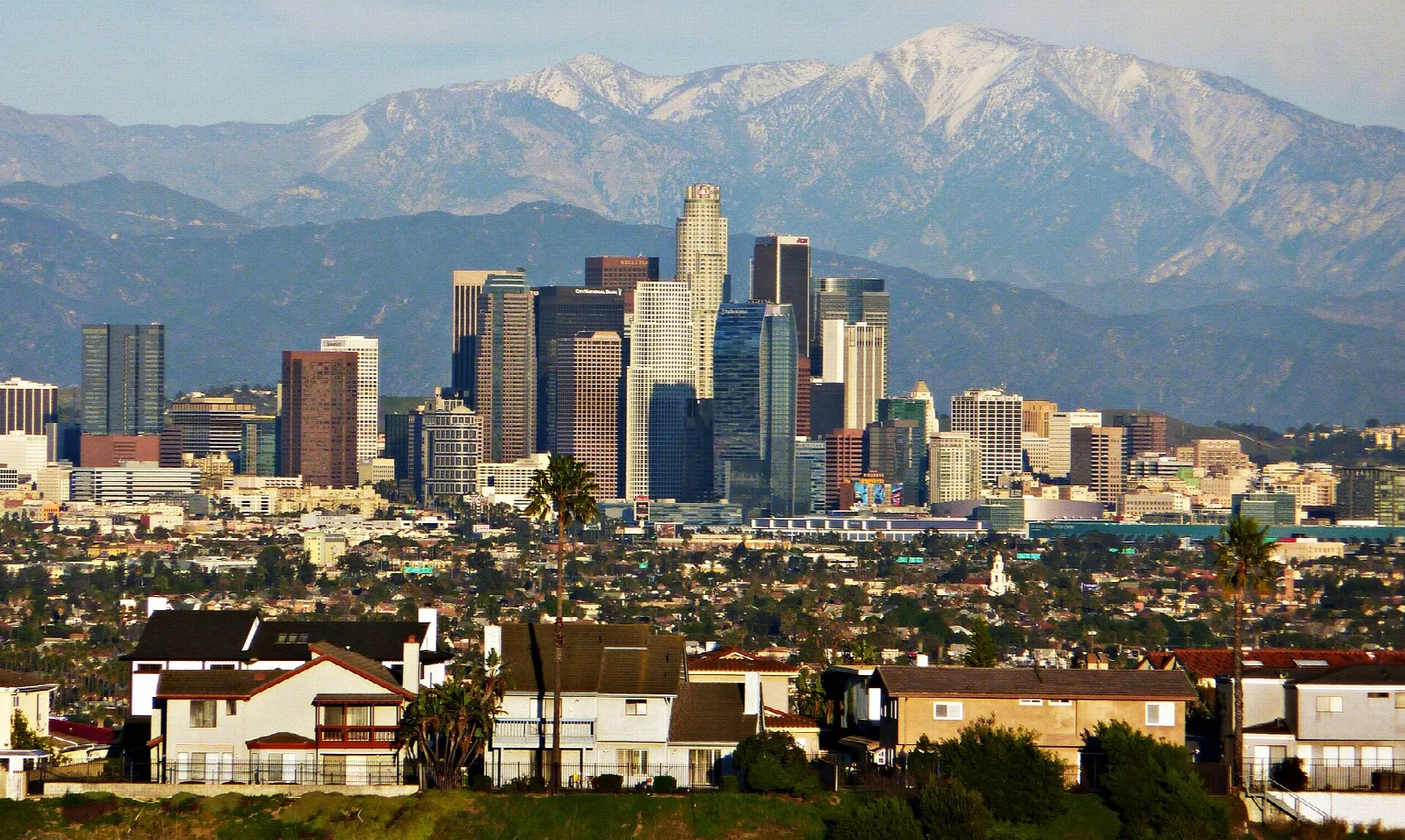 Downtown skyline with snowy mountains behind