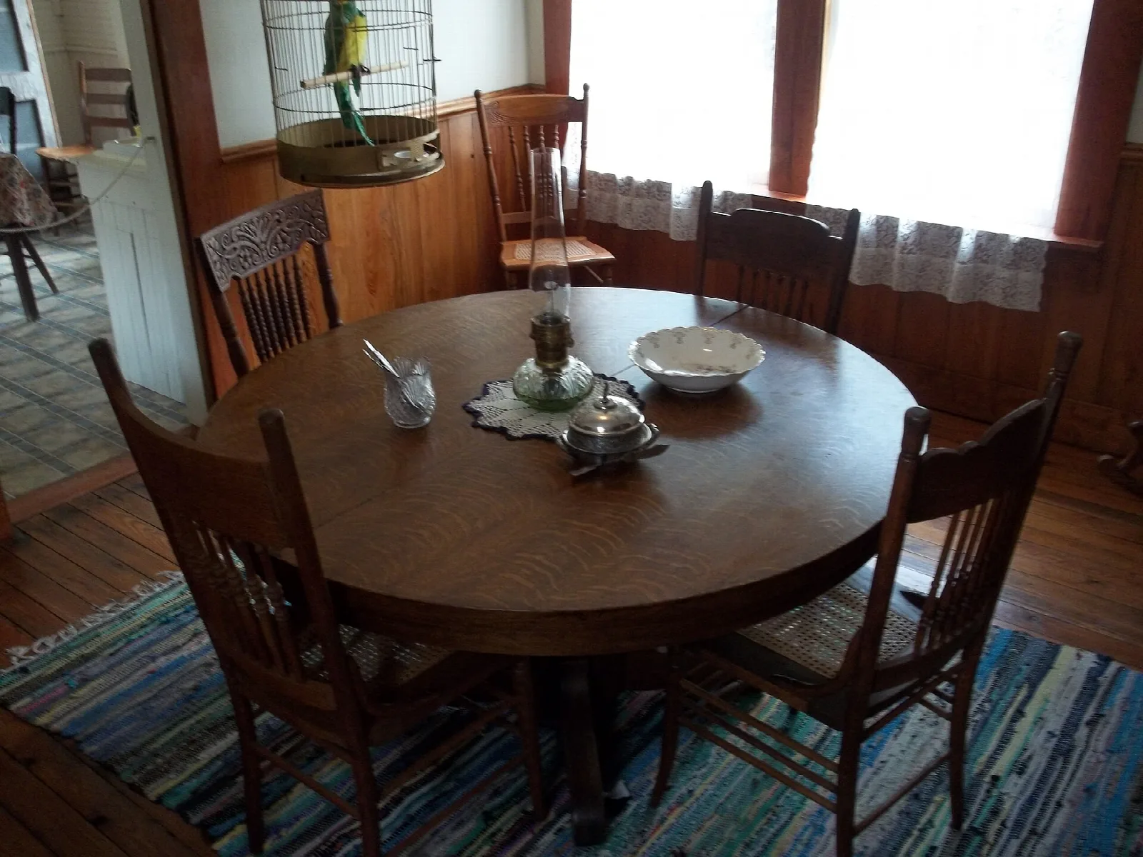 Wooden dining room with a round table and set of chairs