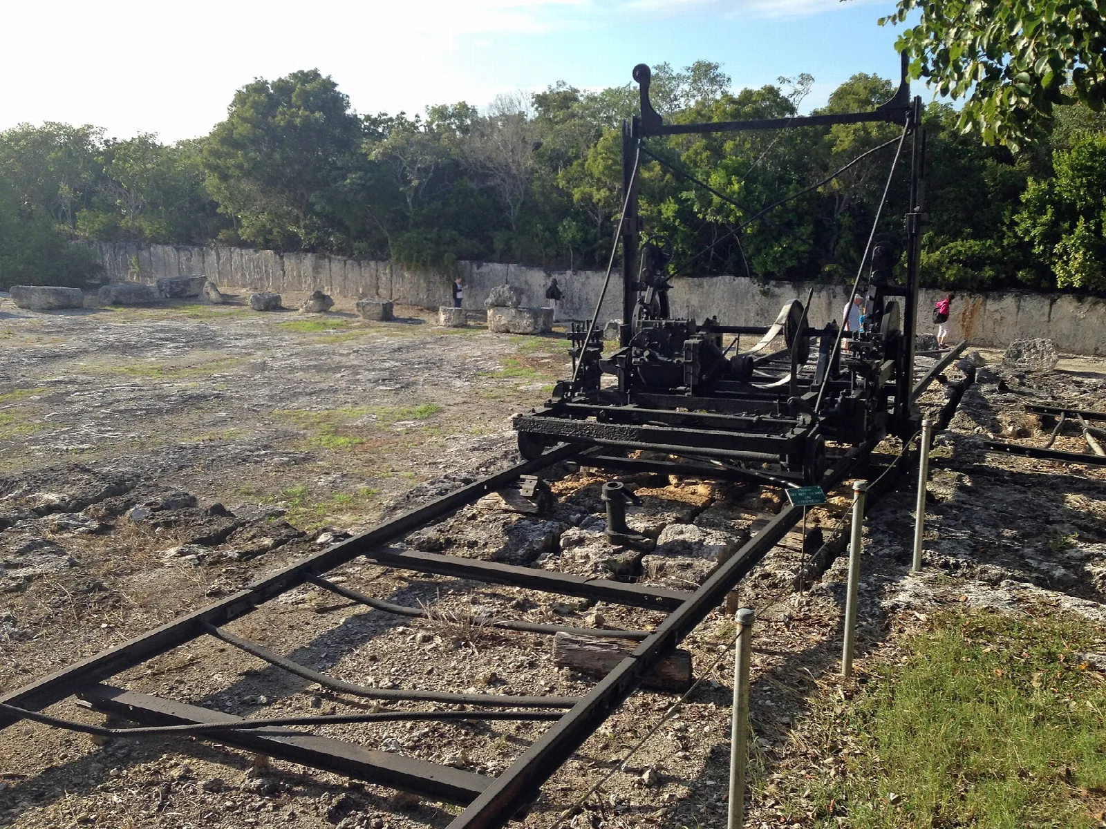 Old black quarry machine on rail tracks