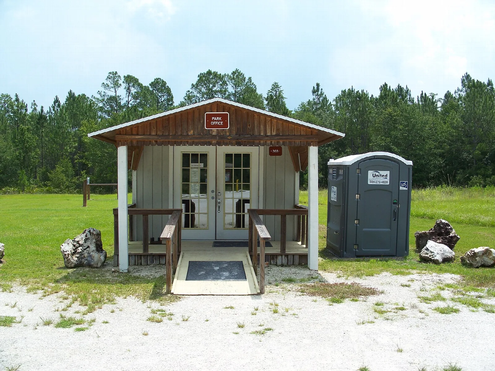 Small ranger station with a porch and a portable toilet