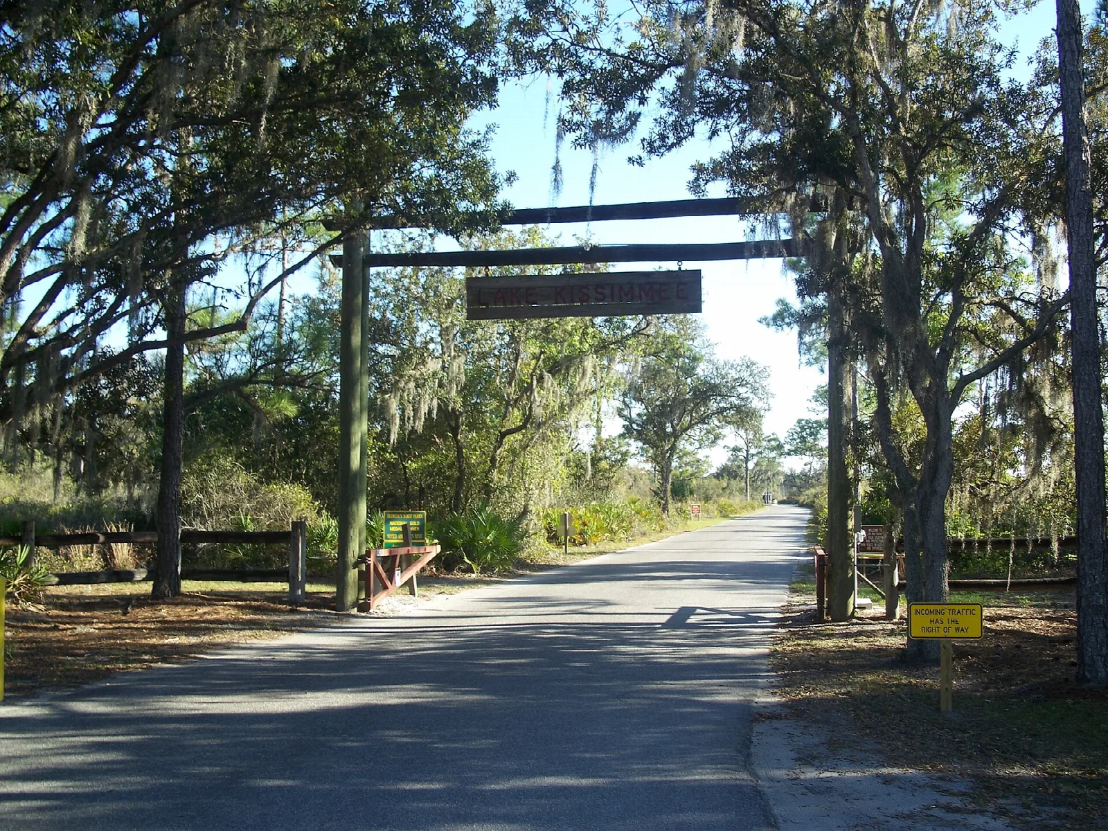 Road entering the park under a wooden gateway